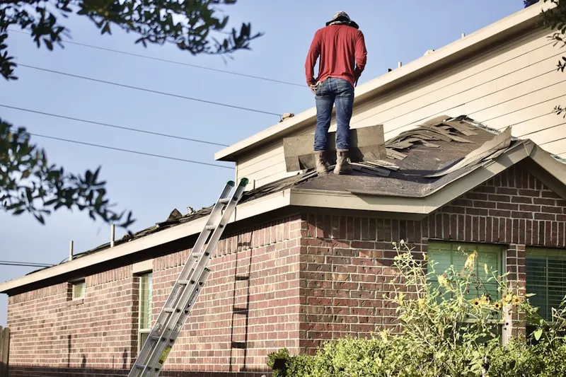 Professional roofer working on a residential roof in Saddleback Estates